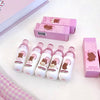 Set of bear-themed bottles and boxes on a light pink background
