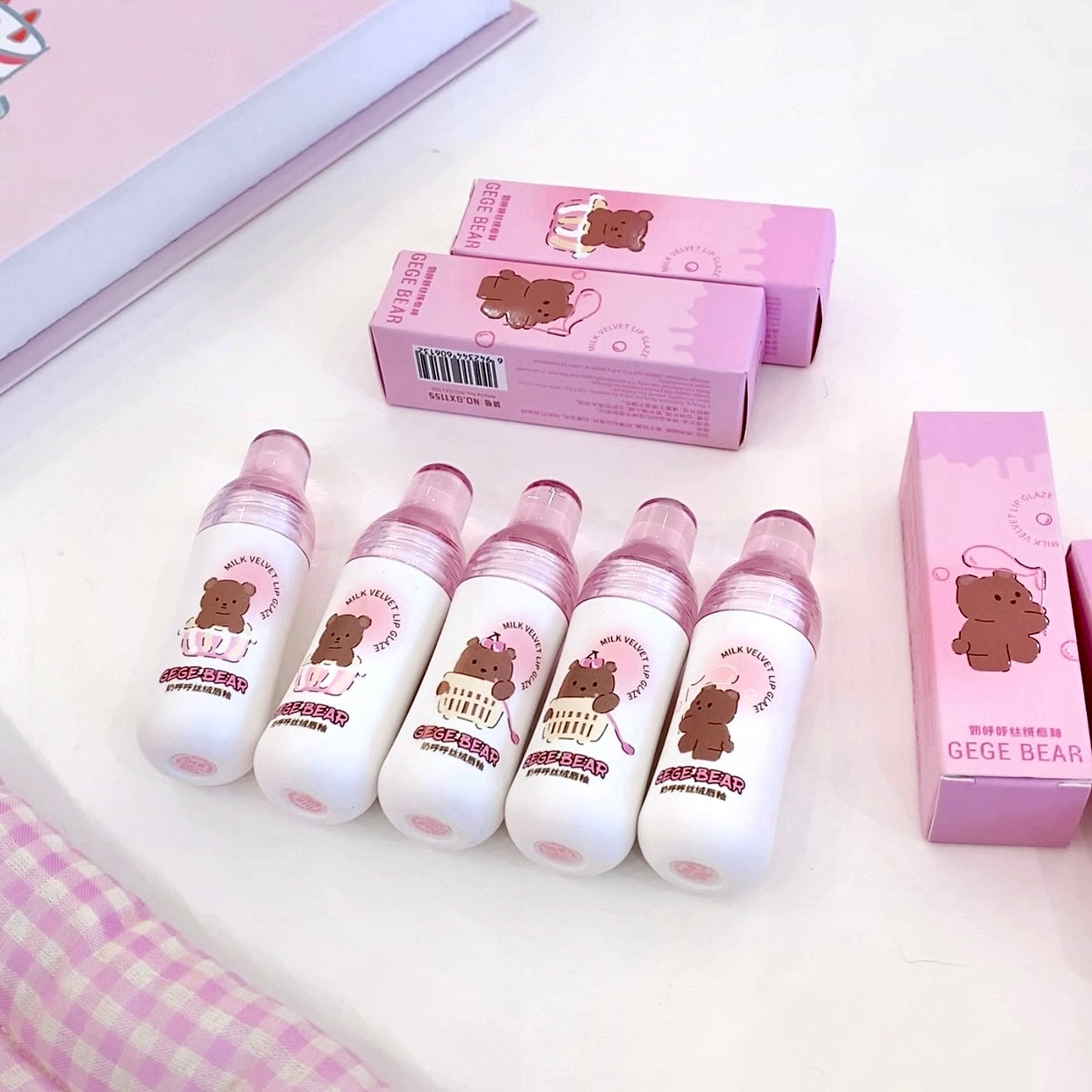 Set of bear-themed bottles and boxes on a light pink background