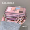 Makeup product with 'GEGE BEAR' branding held by a hand against a neutral background