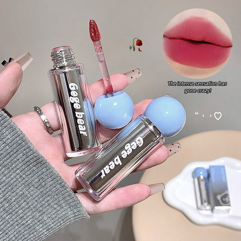 Two lip glosses with 'Gegg bear' branding held by a hand, with a close-up of lips wearing the product.