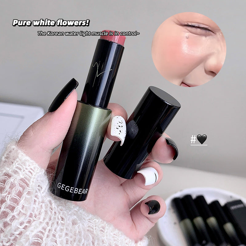Hand holding a black lipstick with 'GEBEARE' branding, close-up of lips, and text overlay.