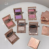 Makeup products with colorful powders on a white surface