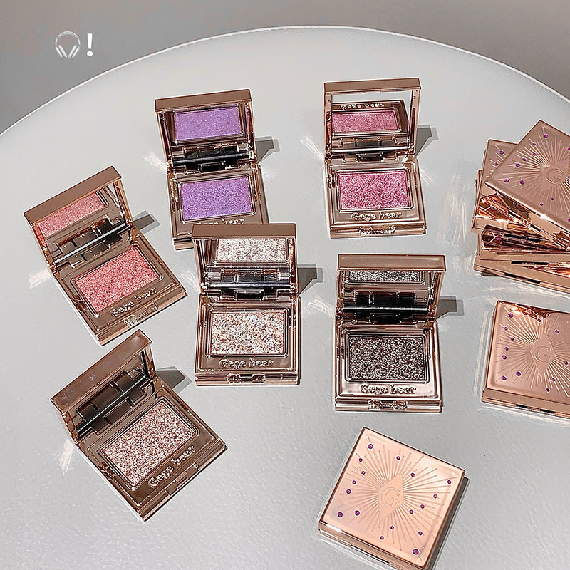 Makeup products with colorful powders on a white surface
