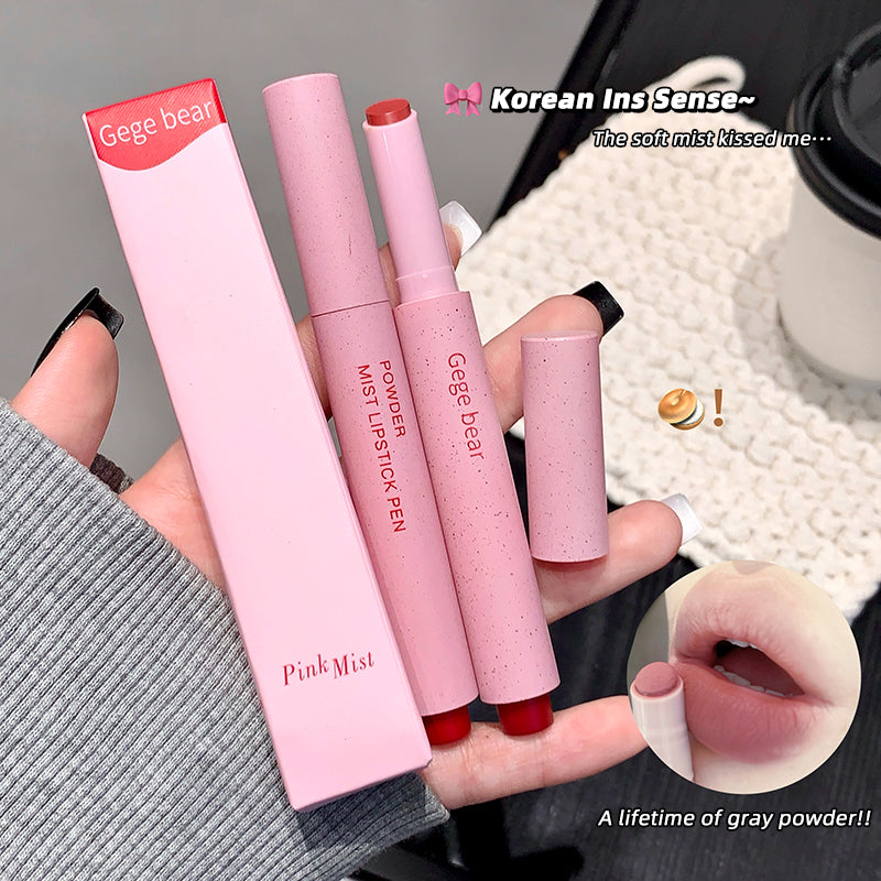 Pink lip products with 'Gege bear' branding held by a hand on a textured surface.