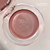 Compact blush with a pink shade on a white background