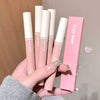 Hand holding pink lip glosses with 'Gege bear' branding against a neutral background