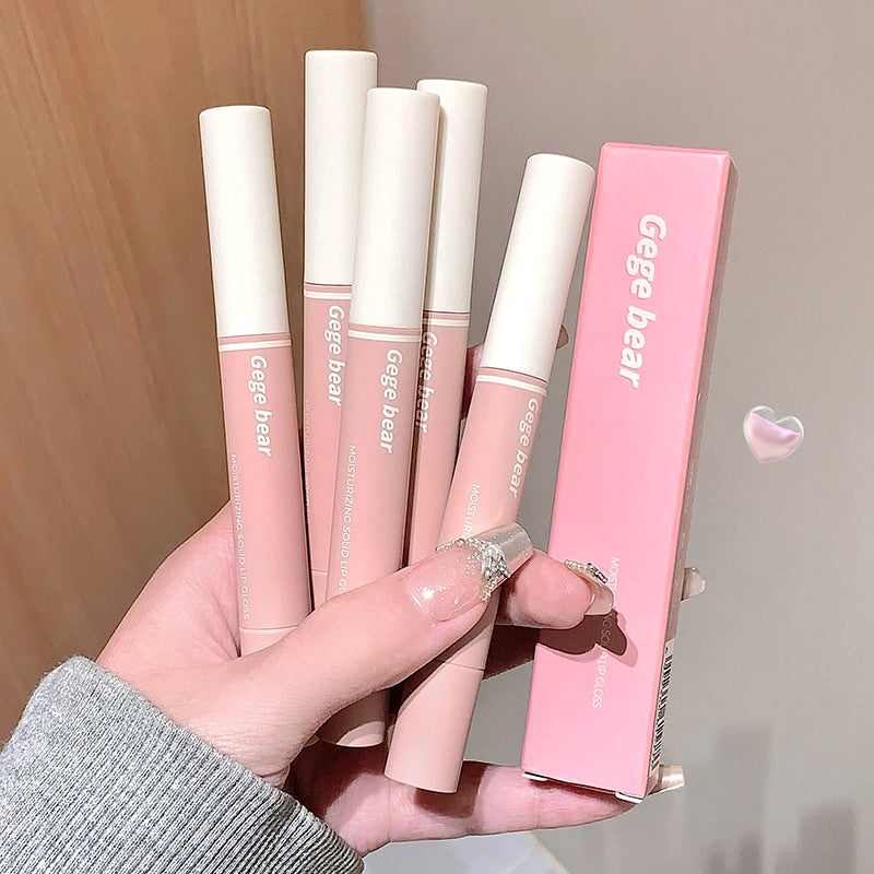 Hand holding pink lip glosses with 'Gege bear' branding against a neutral background