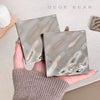 Two metallic compact mirrors held in a hand with 'GEGE BEAR' branding.