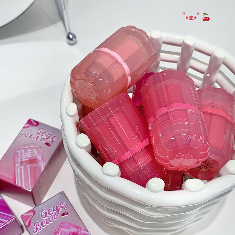 Pink containers with 'Gee Bear' branding in a white basket on a light background