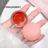 Hand holding a small jar of red cream and a pink ball, with 'New product!' text and cherry icon.