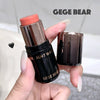 Lipstick with 'GEGE BEAR' branding held by a hand against a neutral background