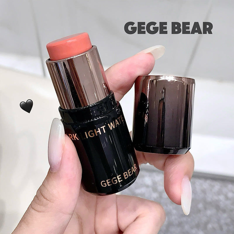Lipstick with 'GEGE BEAR' branding held by a hand against a neutral background