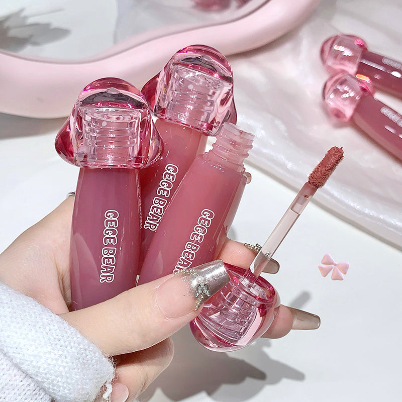 Pink lip gloss with applicator held by a hand, brand 'CECIBEAR' visible