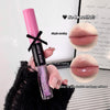 Lip gloss with pink cap and black label held by a hand, close-up of lips with product application.