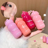 Hand holding four pink lip balm tubes with 'Versatile Blush Stick' branding.