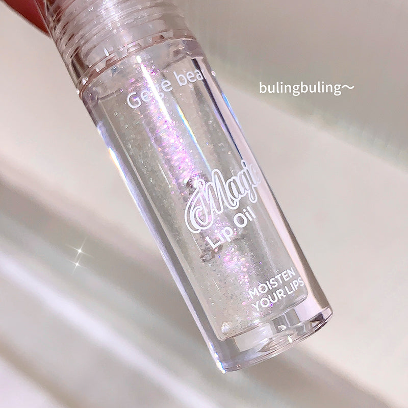 Lip oil bottle with glittery texture on a light background