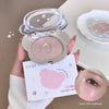 Compact powder with a mirror held by a hand, with a blurred face in the foreground.