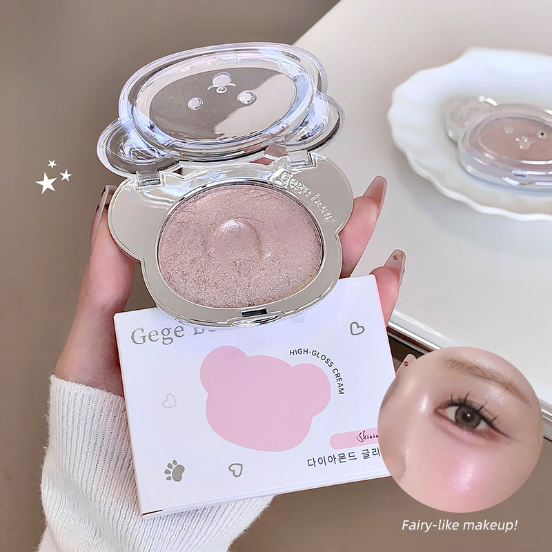 Compact powder with a mirror held by a hand, with a blurred face in the foreground.