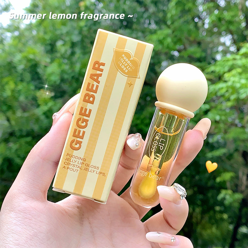 Lip balm with packaging labeled 'GEGE BEAR' held by a hand against a green outdoor background.