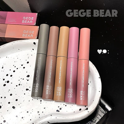 Five GEGE BEAR lip products on a white plate with black speckles, against a black background.