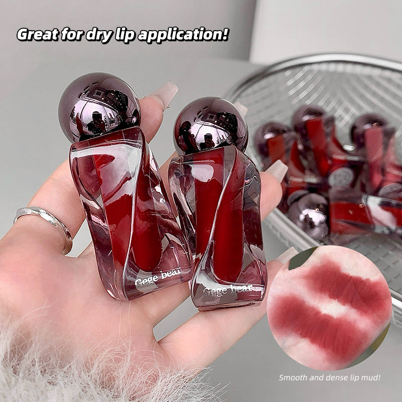 Two lip products held in a hand with text indicating their use for dry lips, and an inset showing a close-up of a smooth and dense lip mud.
