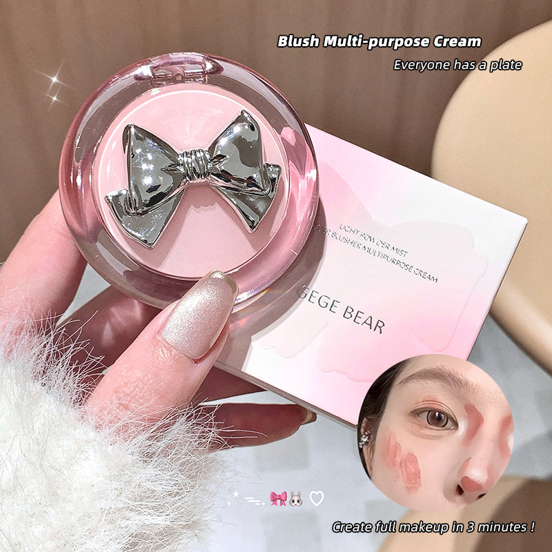 Pink multi-purpose cream with a silver bow held by a hand, next to its packaging.