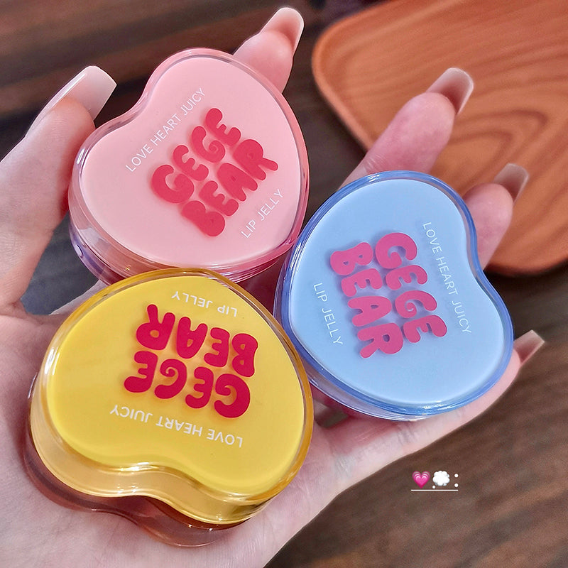 Three heart-shaped lip jelly containers with 'GEGE BEAR' branding held in a hand.