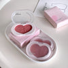 Heart-shaped blush compact with open lid on a white surface