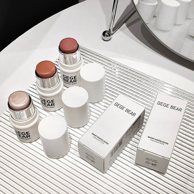 Cosmetic products and boxes with 'GEGE BEAR' branding on a white surface.