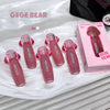 Pink lip gloss with 'GEGE BEAR' branding on a white surface.
