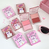 Pink makeup products with bear design packaging on a white background