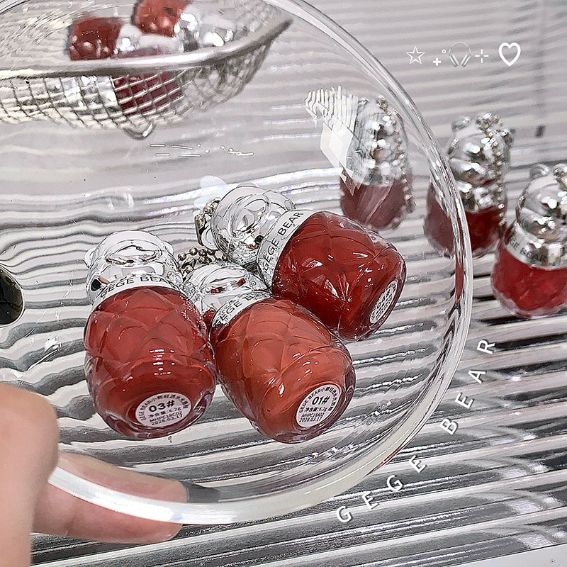 Red and silver bear-shaped candies in a clear glass bowl with 'Gee Bear' branding.