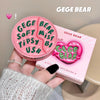 Pink 'GEGE BEAR' makeup product held by a hand with a matching box in the background.