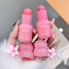 Two pink blush sticks with 'Gege bear' branding held by a hand.