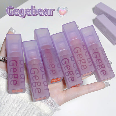 Hand holding multiple purple 'Gege' lip balm containers with 'Gegebear' branding.