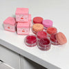 Pink cosmetic jars and boxes with 'Gee Bear' branding on a white surface.