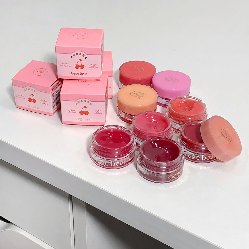 Pink cosmetic jars and boxes with 'Gee Bear' branding on a white surface.