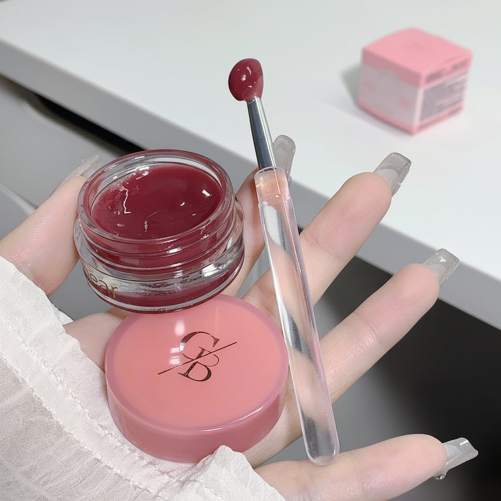 Lip balm with applicator held by a hand on a white background