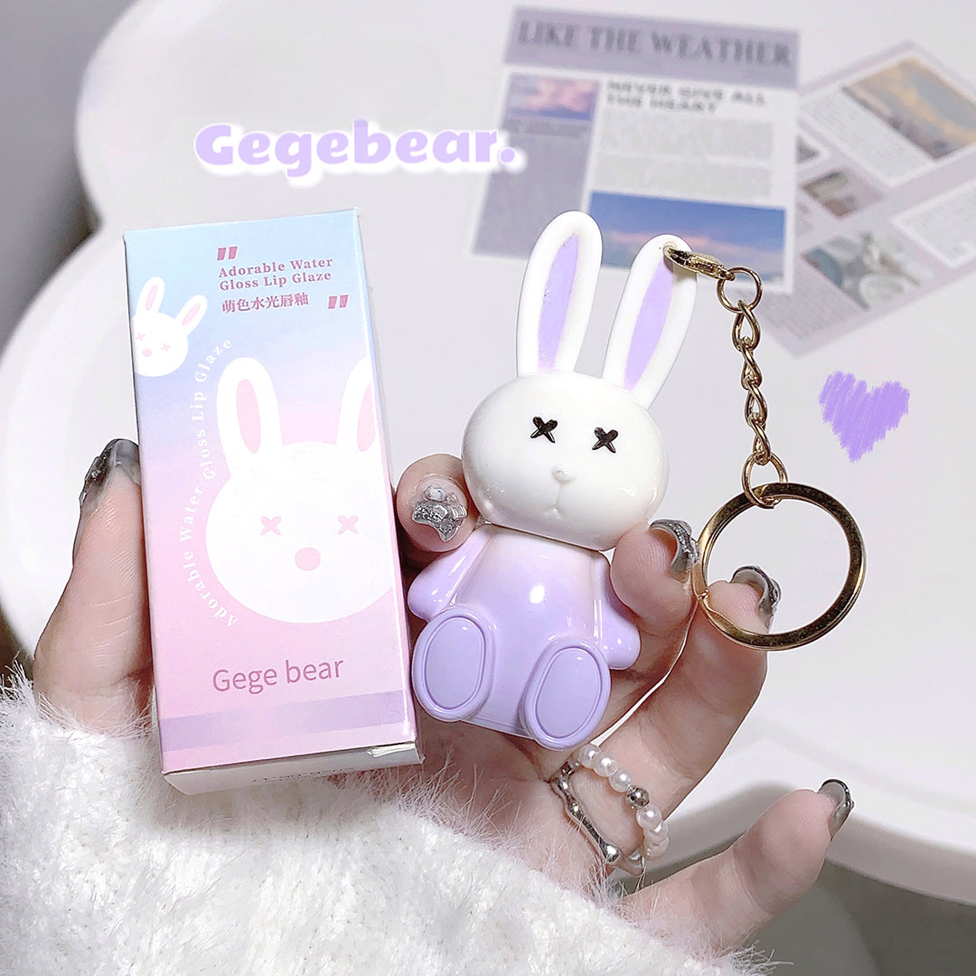 Cute bunny-shaped product with a keychain held by a hand, next to its packaging.