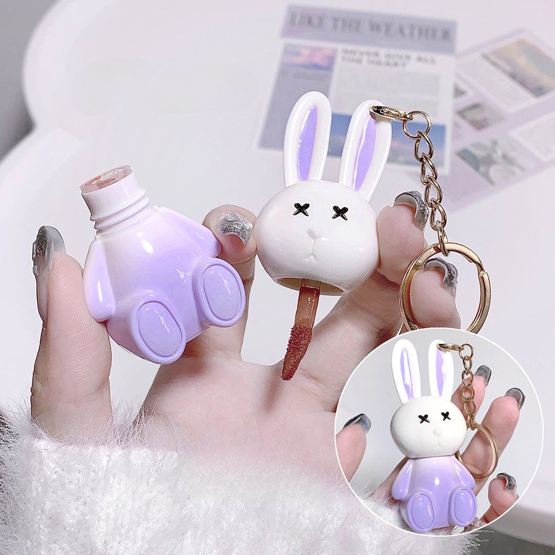Lipstick with rabbit design holder and keychain on a blurred background