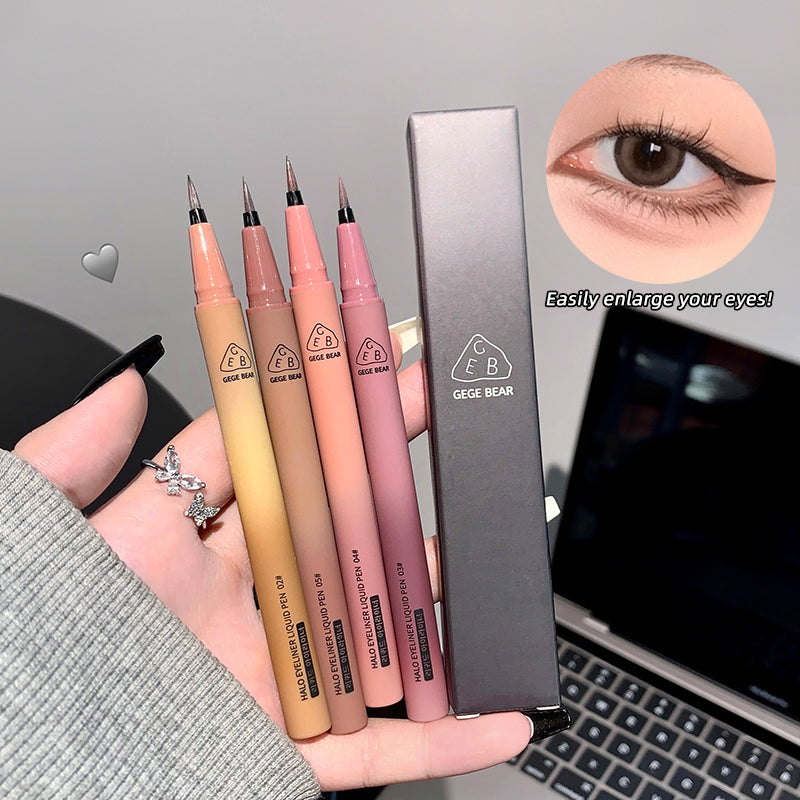 Set of makeup pencils with a box, displayed on a hand with a laptop in the background.