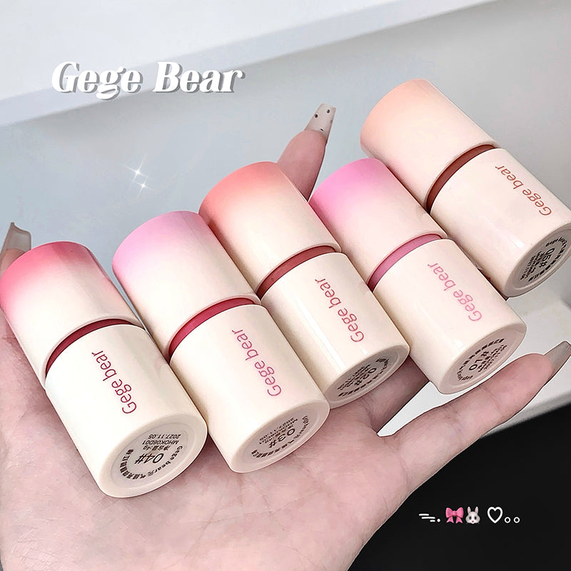 Set of Gege Bear lip balms on a hand with a white background