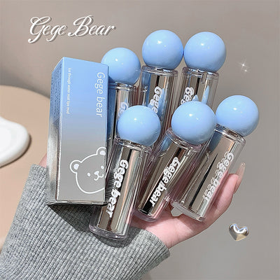 Set of Gege Bear lip balms with blue caps held in a hand against a neutral background.