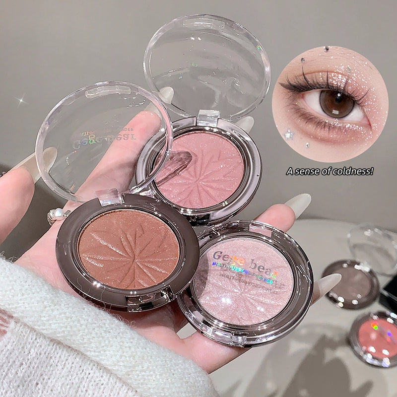 Three makeup compact powders with a hand holding them, one showing an eye wearing the product.