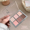 Makeup eyeshadow palette with six shades held by a hand on a neutral background