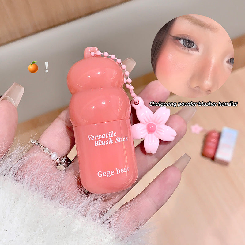Pink blush stick with 'Versatile Blush Stick Gege bear' text, held by a person.