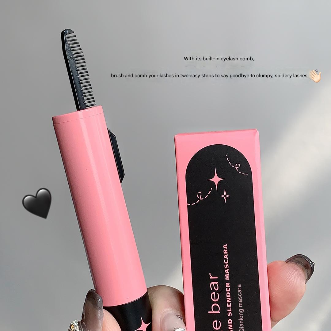 Pink mascara with built-in eyelash comb and packaging on a gray background