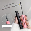 Black and pink mascara with a brush on a gray background