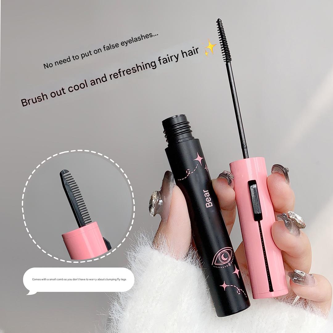 Black and pink mascara with a brush on a gray background