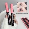 Two pink makeup products with black accents held by a hand, with an inset showing eye makeup application.